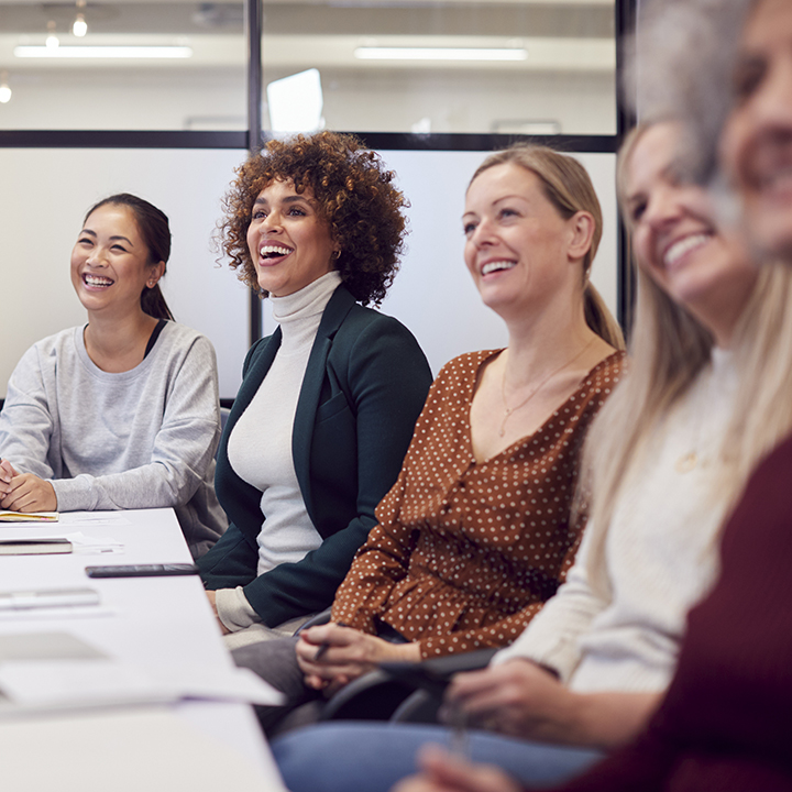 a group of women sitting next to each other at a table