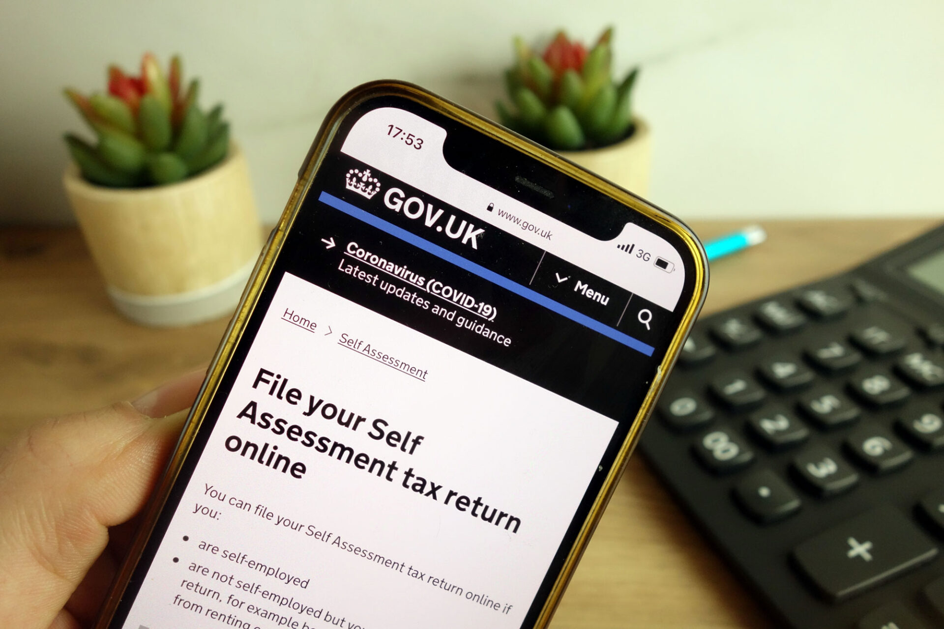 a close up of a mobile screen shows the government website tax return page